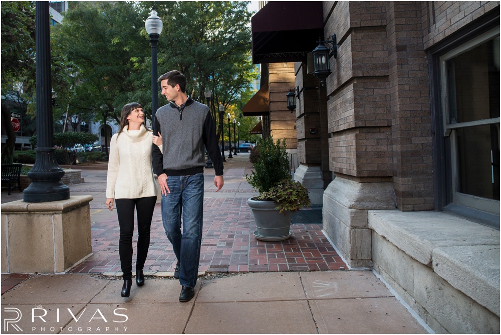 Timeless Garment District Engagement Session | Picture of engaged couple in fall sweaters walking through Kansas City's Garment District. 