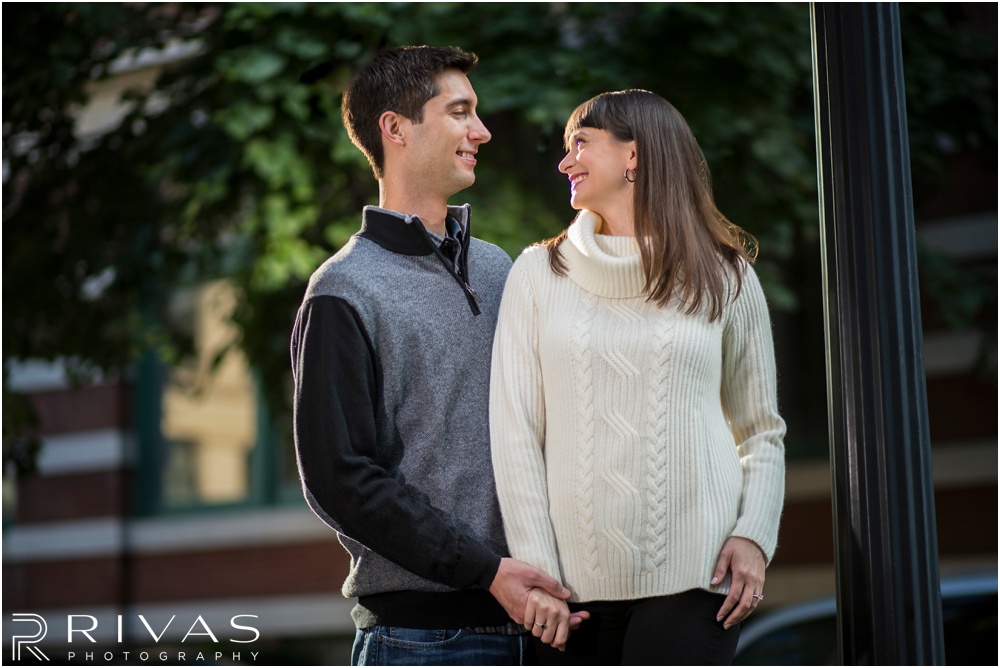 Timeless Garment District Engagement Session | Picture of engaged couple in fall sweaters hugging in Kansas City's Garment District. 