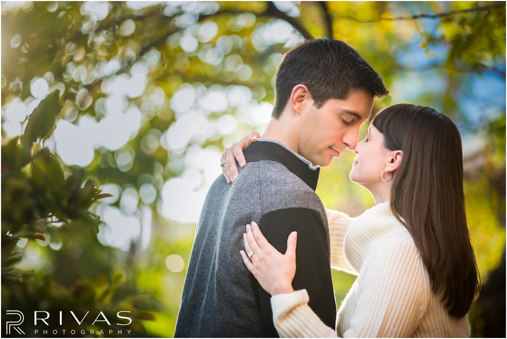 Timeless Garment District Engagement Session | A picture of an engaged couple in fall sweaters sitting on a bench in downtown Kansas City. 