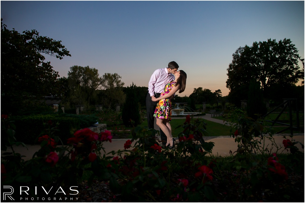 Timeless Garment District Engagement Session | A picture of an engaged couple kissing in the rose garden at Loose Park. 