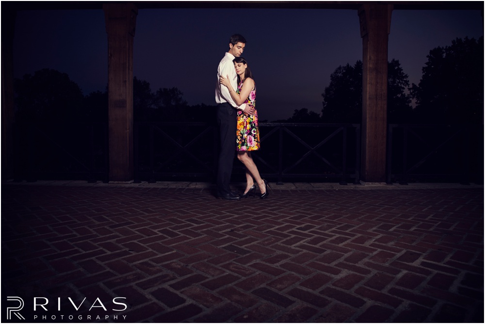 Timeless Garment District Engagement Session | A picture of an engaged couple hugging in the rose garden at Loose Park. 