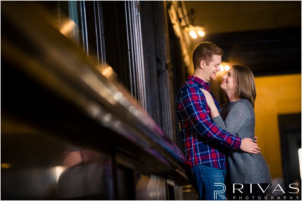 Colorful Fall Engagement Session |  A close-up photo of an engaged couple embracing inside Kansas City's Union Station. 