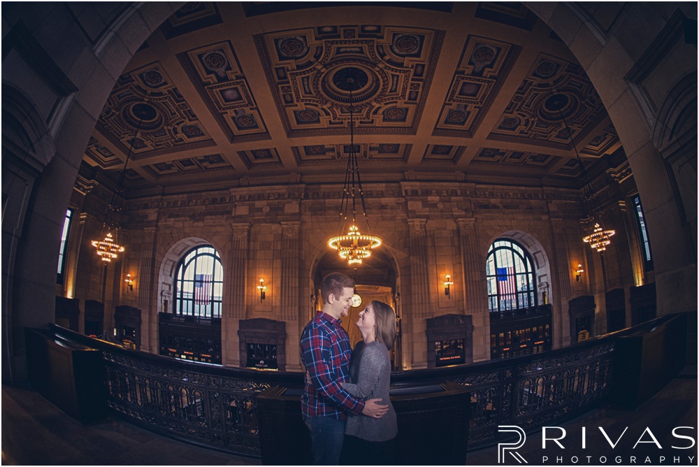 Colorful Fall Engagement Session |  A dramatic picture of an engaged couple embracing on the upper balcony at Kansas City's Union Station. 