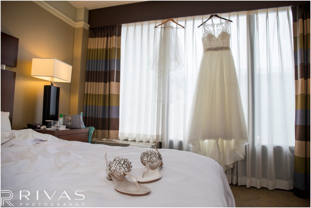 Rustic Outdoor Fall Wedding | A picture of a bride's wedding gown and shoes in a downtown Kansas City hotel room. 