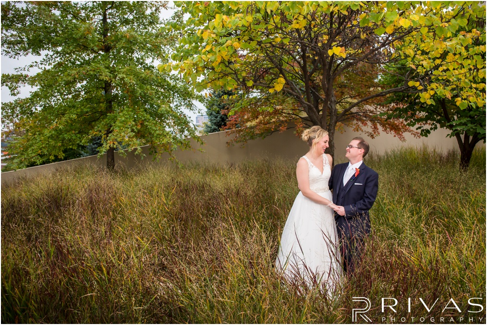 Rustic Outdoor Fall Wedding | Two candid photos of a bride and groom on the north side of The Kauffman Center for Performing Arts on their wedding day. 