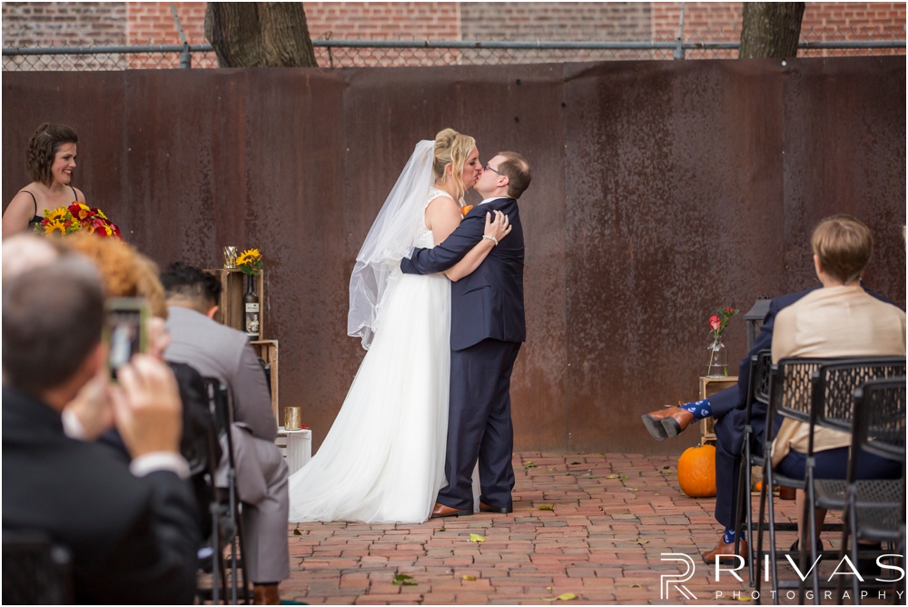 Rustic Outdoor Fall Wedding | A picture of a bride and groom sealing their vows with a kiss at the end of their wedding ceremony. 