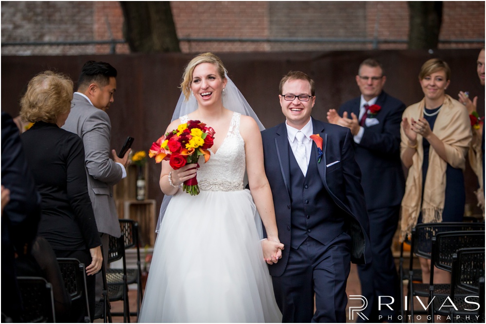 Rustic Outdoor Fall Wedding | A picture of a bride and groom smiling as they walk back down the aisle after their wedding ceremony. 