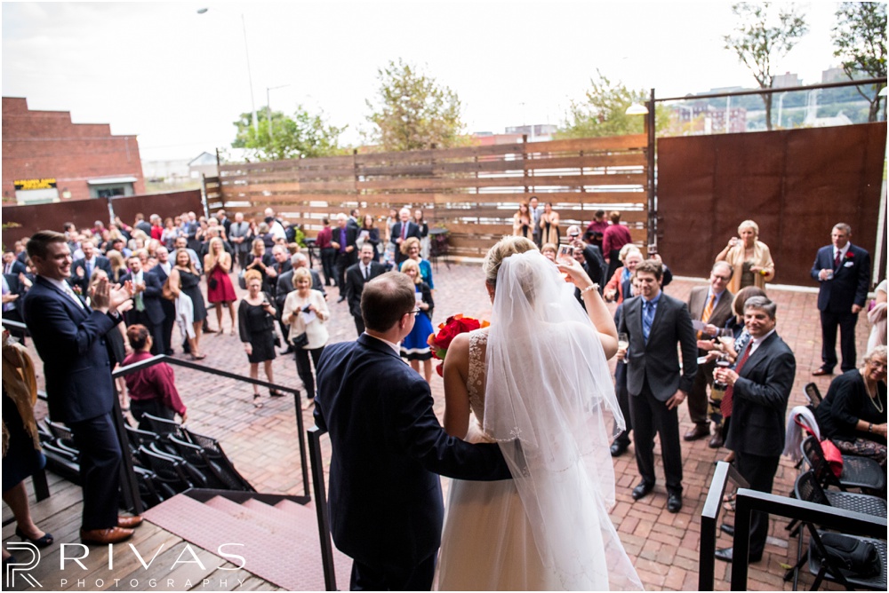 Rustic Outdoor Fall Wedding | A photo of a bride and groom greeting their wedding guests at an outside cocktail hour. 
