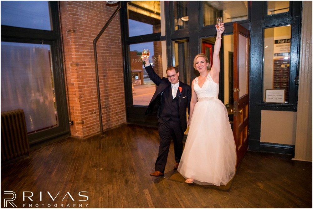 Rustic Outdoor Fall Wedding | A candid picture of a bride and groom entering their wedding reception. 