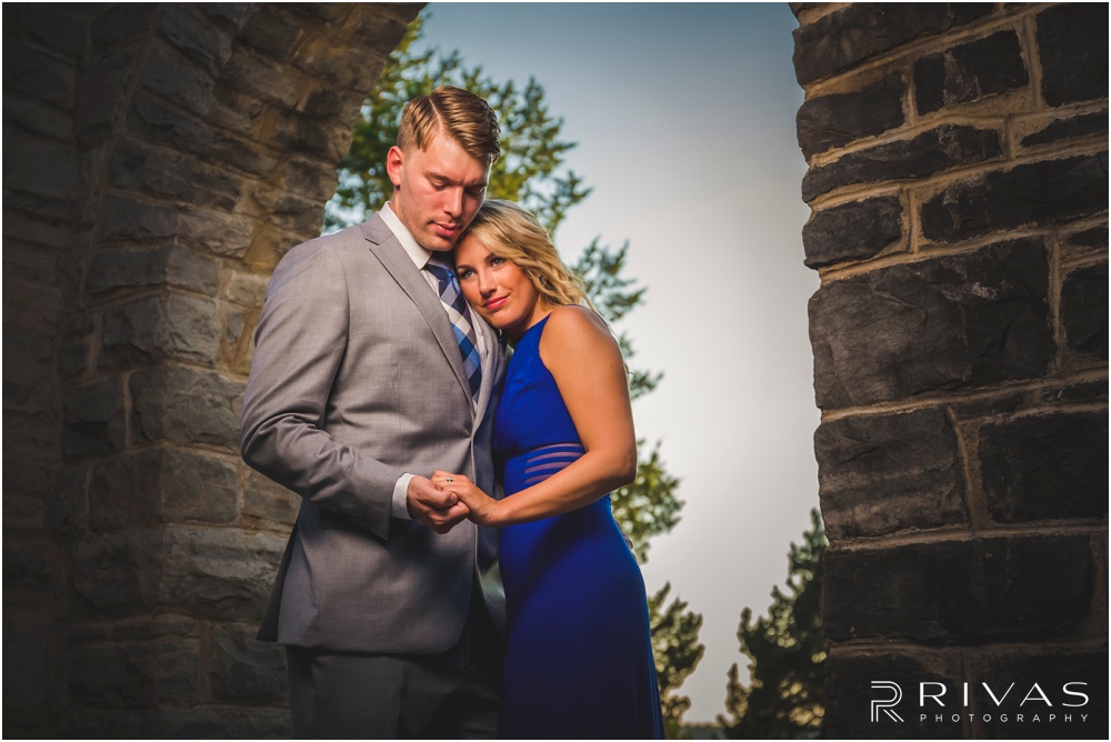romantic castle ruins engagement pictures | A picture of an engaged couple holding hands at the top of a flight of stairs. 