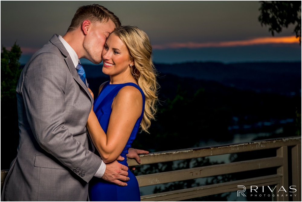 romantic castle ruins engagement pictures | A photo of an engaged couple embracing overlooking the Lake of the Ozarks at sunset. 