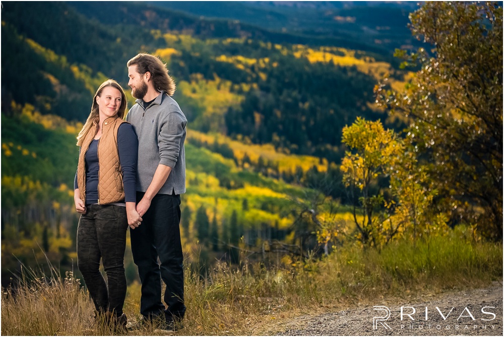 Fall Aspen Engagement Session | A photo of an engaged couple standing on a boulder at a roadside park outside Aspen, Colorado. 