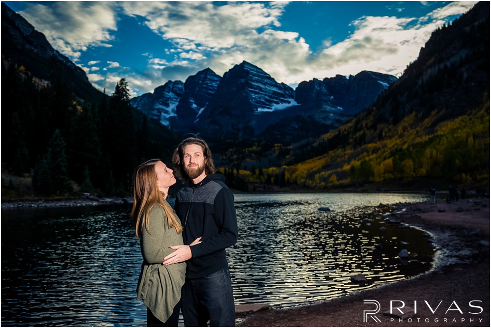 Fall Aspen Engagement Session | A picture of an engaged couple in fall sweaters by the lake at Maroon Bells near Aspen, Colorado. 