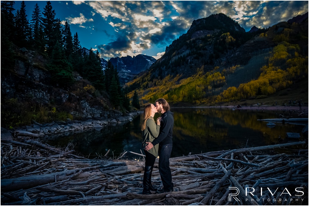 Fall Aspen Engagement Session | A photo of an engaged couple in fall sweaters by the lake at Maroon Bells near Aspen, Colorado. 