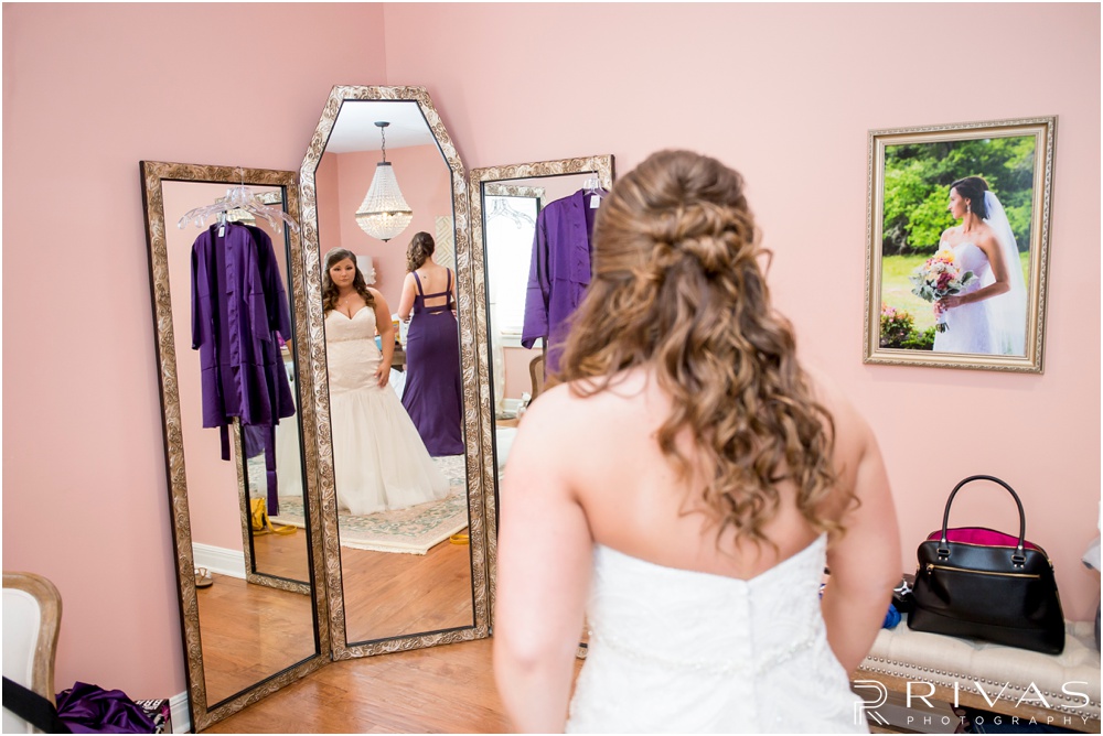 elegant fall wedding buffalo lodge | A bride looking in the mirror in the Bridal Suite at The Buffalo Lodge. 