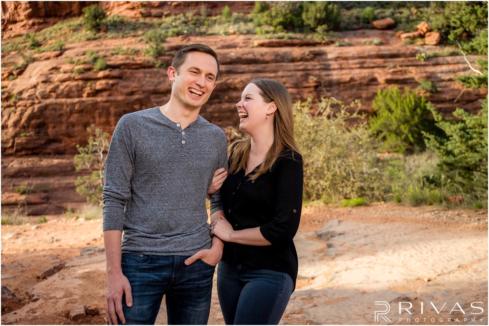 Merry-Go-Round Rock Engagement Session | Picture of an engaged couple standing in front of red rocks in Sedona. 