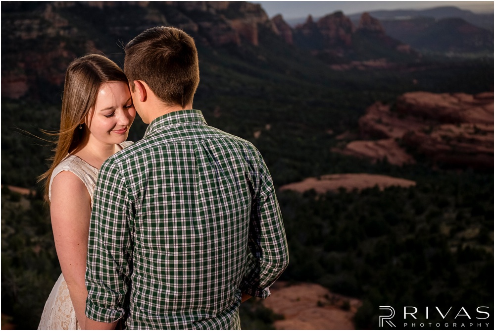 Merry-Go-Round Rock Engagement Session | Picture of an engaged couple standing on a cliff at Merry-Go-Round Rock in Sedona. 