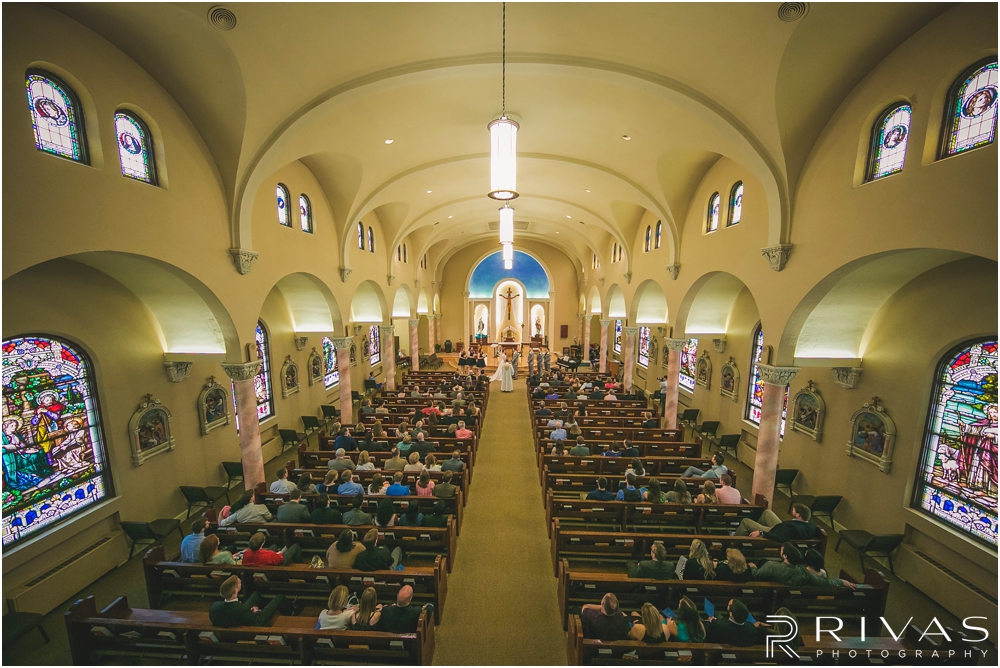 St. John the Evangelist Catholic Church Spring Wedding | A photo of a wedding ceremony from the balcony of St. John the Evangelist Catholic Church in Lawrence, KS. 