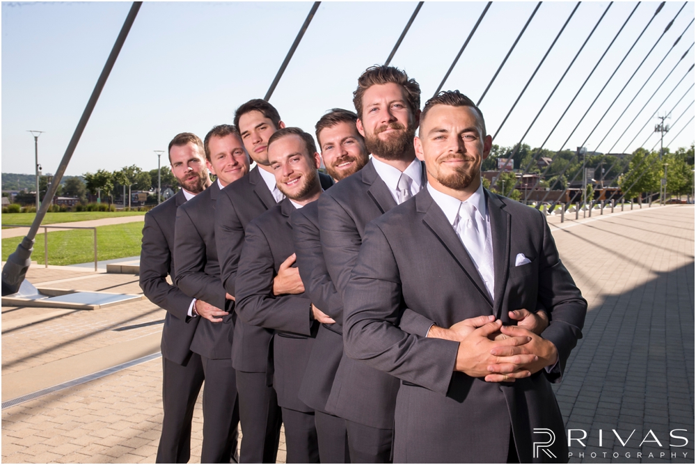 Staley Farms Golf Club Summer Wedding | A candid picture go a groom and his groomsmen at the Kauffman Center for the Performing Arts  after their wedding in Kansas City. 