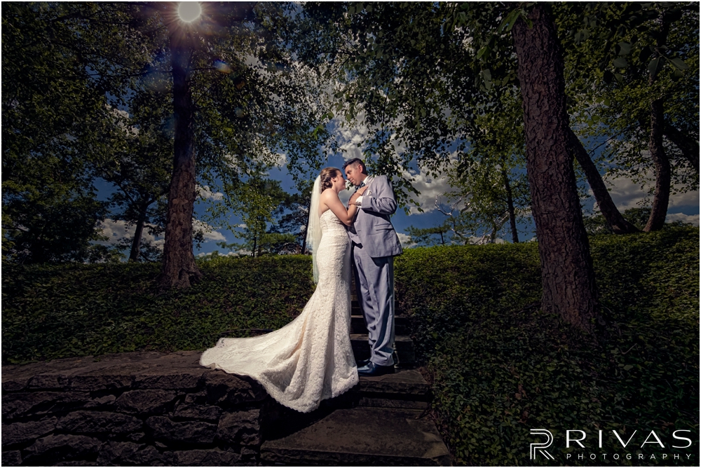 Classic Summer Wedding at Berg Event Space | A dramatic portrait of a bride and groom embracing on their wedding day in the gardens at The Nelson Atkins Museum of Art in Kansas City. 