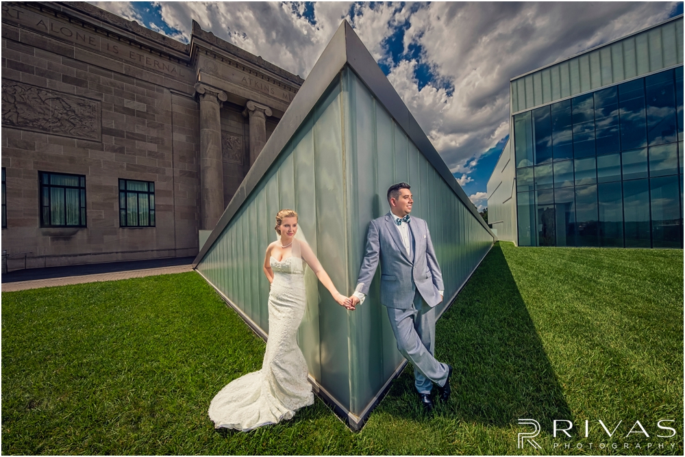 Classic Summer Wedding at Berg Event Space | A dramatic portrait of a bride and groom embracing on their wedding day in the gardens at The Nelson Atkins Museum of Art in Kansas City. 