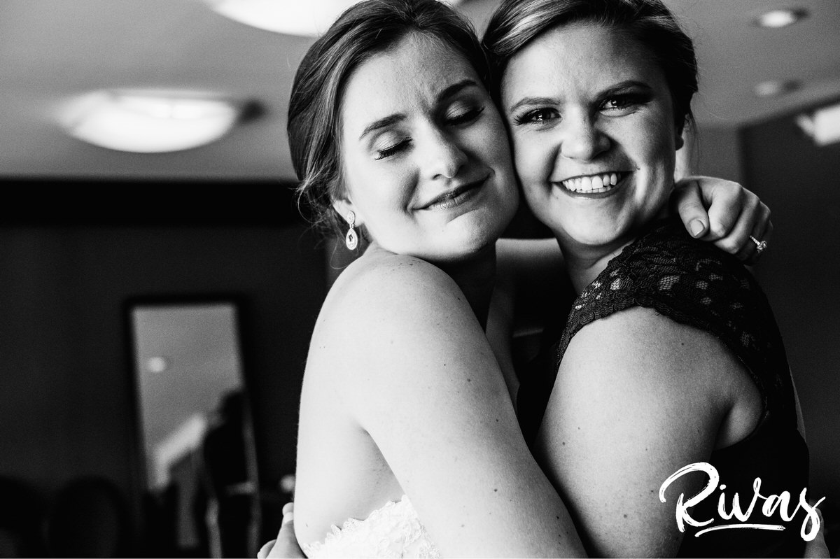 Strawberry Hill Summer Wedding | Rivas Photography | Kansas City Wedding Pictures | A close-up, candid black and white picture of a bride hugging her maid of honor while she tears up on the morning of her wedding day in Kansas City. 