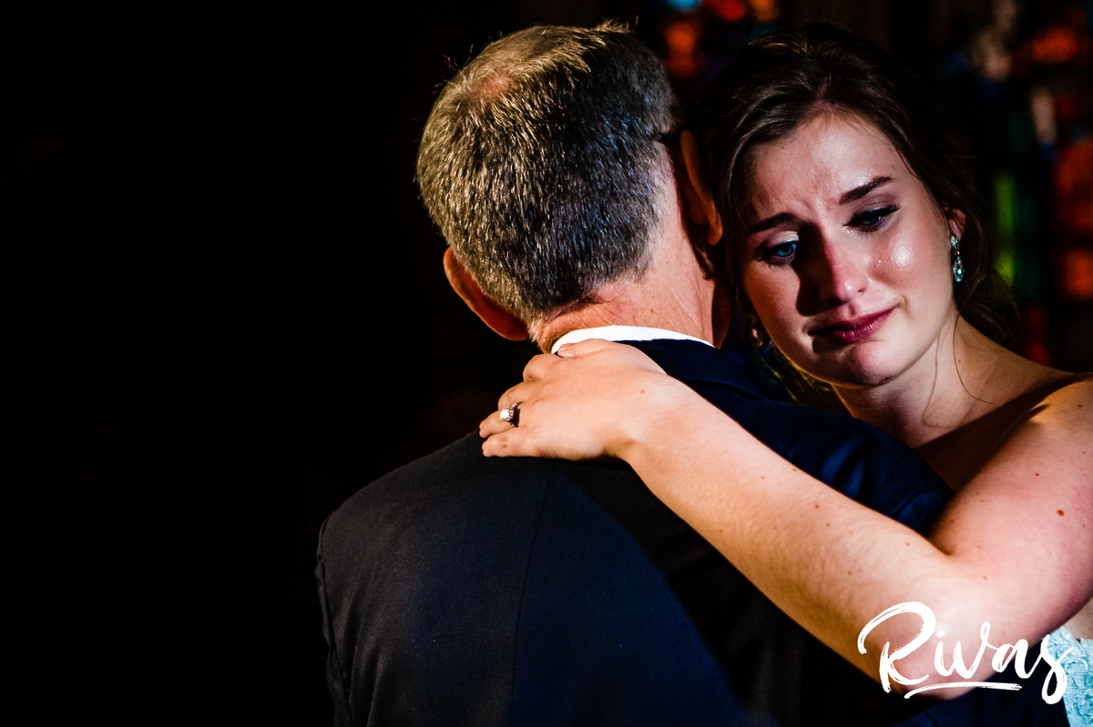 Strawberry Hill Summer Wedding | Rivas Photography | Kansas City Wedding Pictures | A photo of a bride softly crying as she dances with her father during the father-daughter dance of her wedding reception in The Tudor Room at Kansas City's Brass o Baltimore. 