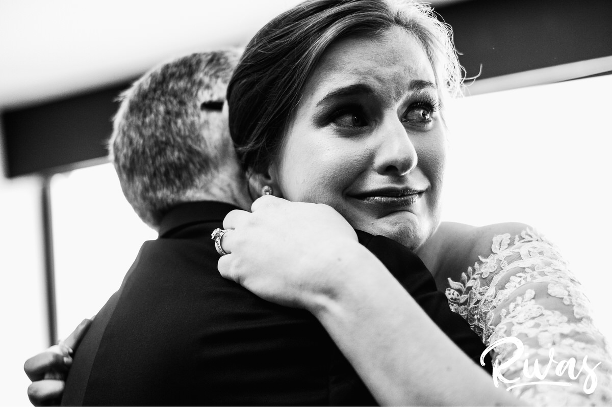 Strawberry Hill Summer Wedding | Rivas Photography | Kansas City Wedding Pictures | A close-up black and white picture of a bride hugging her father just after seeing him for the first time on the morning of her wedding day in Kansas City. 