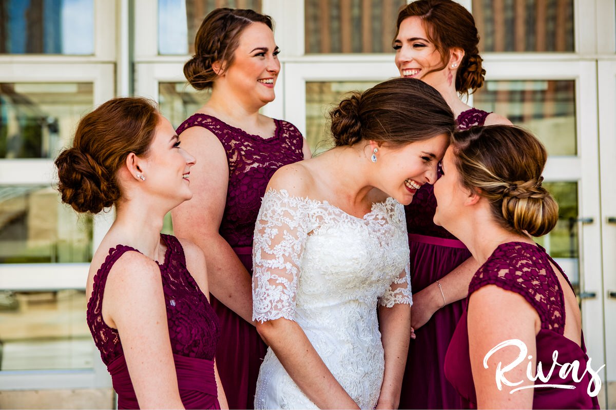 Strawberry Hill Summer Wedding | Rivas Photography | Kansas City Wedding Pictures | An image of a bride and her four bridesmaids dressed in long burgundy gowns standing on the steps of The Little Theater on the morning of her downtown Kansas City wedding. 