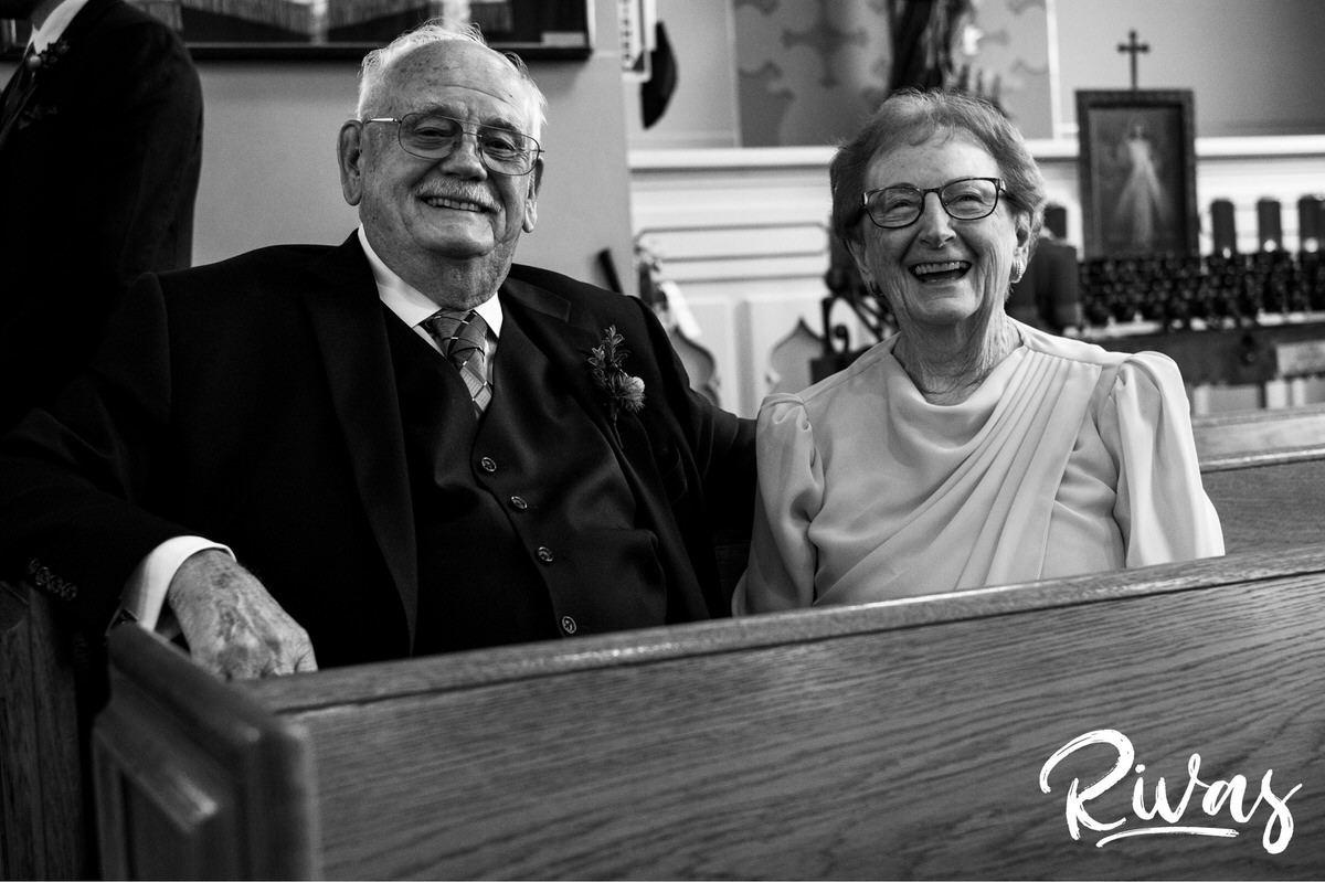 Strawberry Hill Summer Wedding | Rivas Photography | Kansas City Wedding Pictures | A candid picture of a groom's grandparents sitting in a pew before a wedding ceremony. 