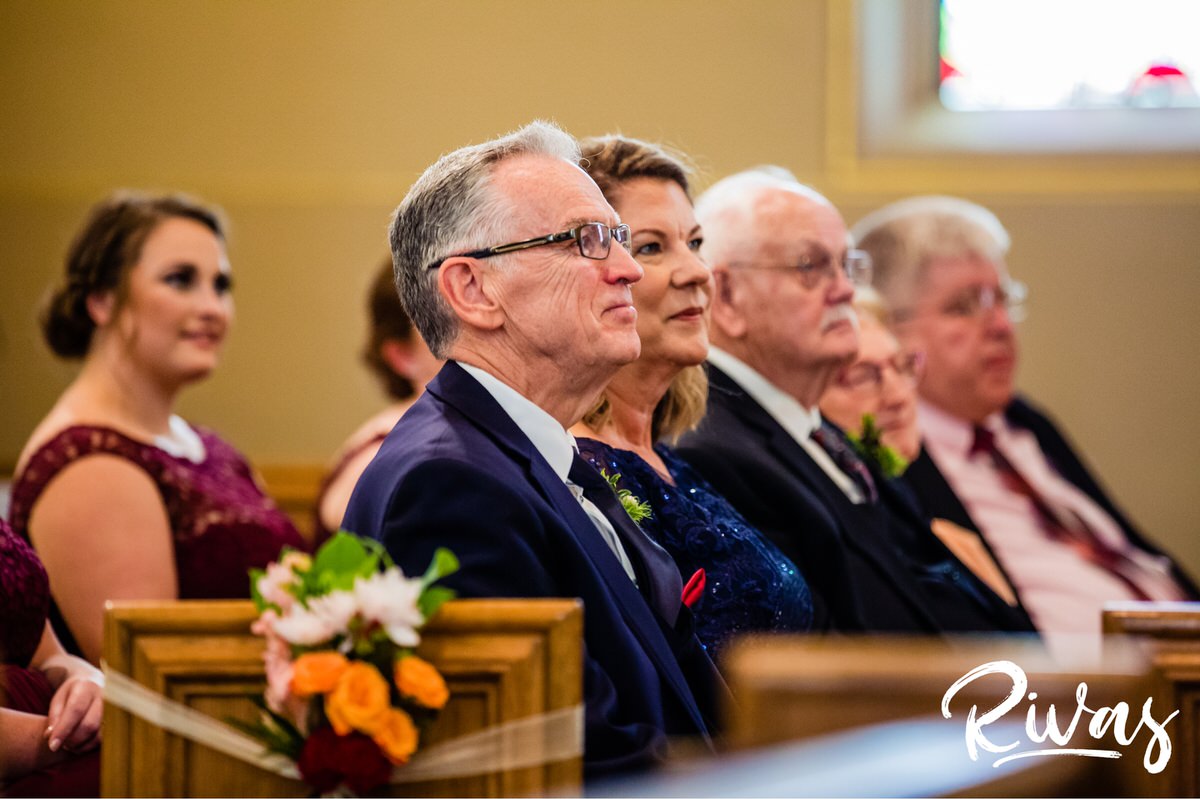 Strawberry Hill Summer Wedding | Rivas Photography | Kansas City Wedding Pictures | An image taken from the front of the church of a bride's parents an grandparents watching the wedding ceremony. 