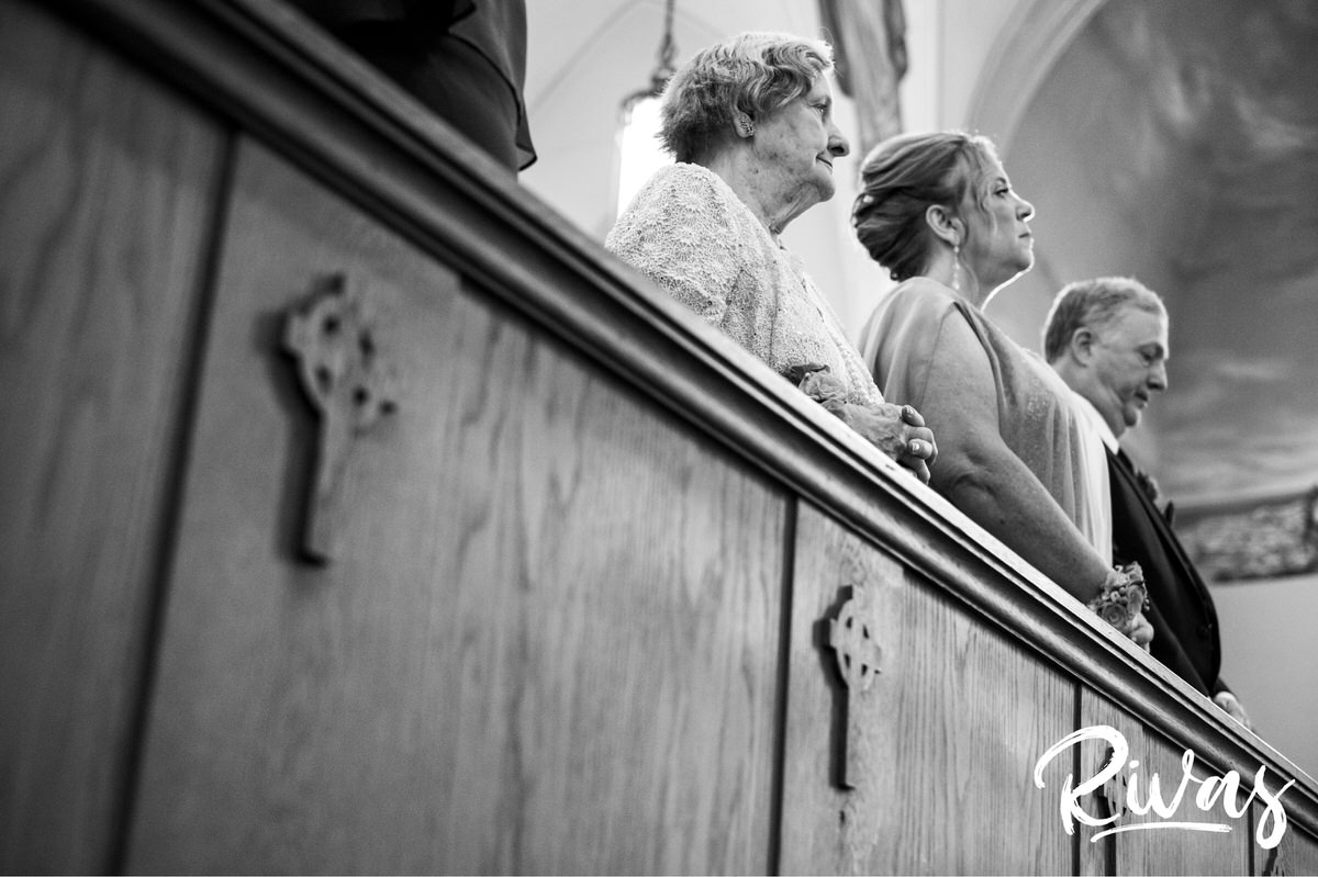 Strawberry Hill Summer Wedding | Rivas Photography | Kansas City Wedding Pictures | photo taken from the ground looking up at a groom's parents and grandmother during a wedding ceremony in Kansas City. 