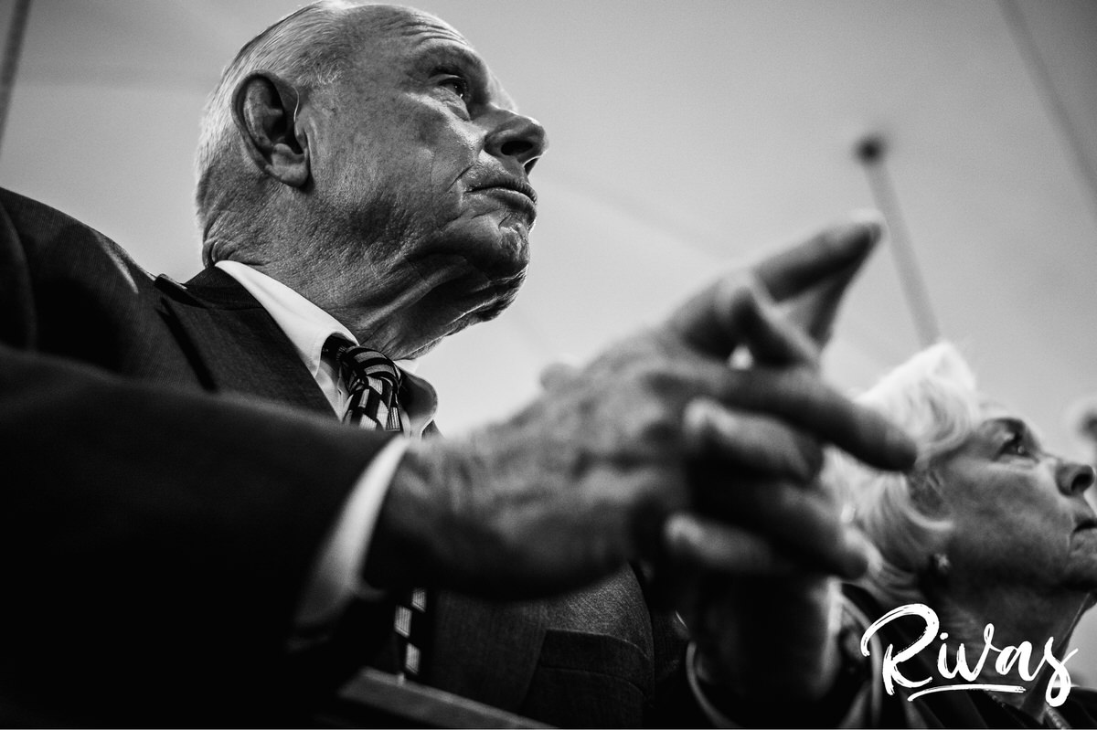 Strawberry Hill Summer Wedding | Rivas Photography | Kansas City Wedding Pictures | A close-up, black and white photo of a groom's grandfather with his head bowed and hands clasped in prayer during a wedding ceremony in Kansas City. 
