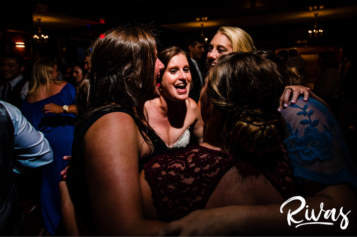 Strawberry Hill Summer Wedding | Rivas Photography | Kansas City Wedding Pictures | A candid photo taken during a wedding reception held in The Tudor Room at Kansas City's Brass on Baltimore of a bride and her friends excitedly singing and dancing on the dance floor. 