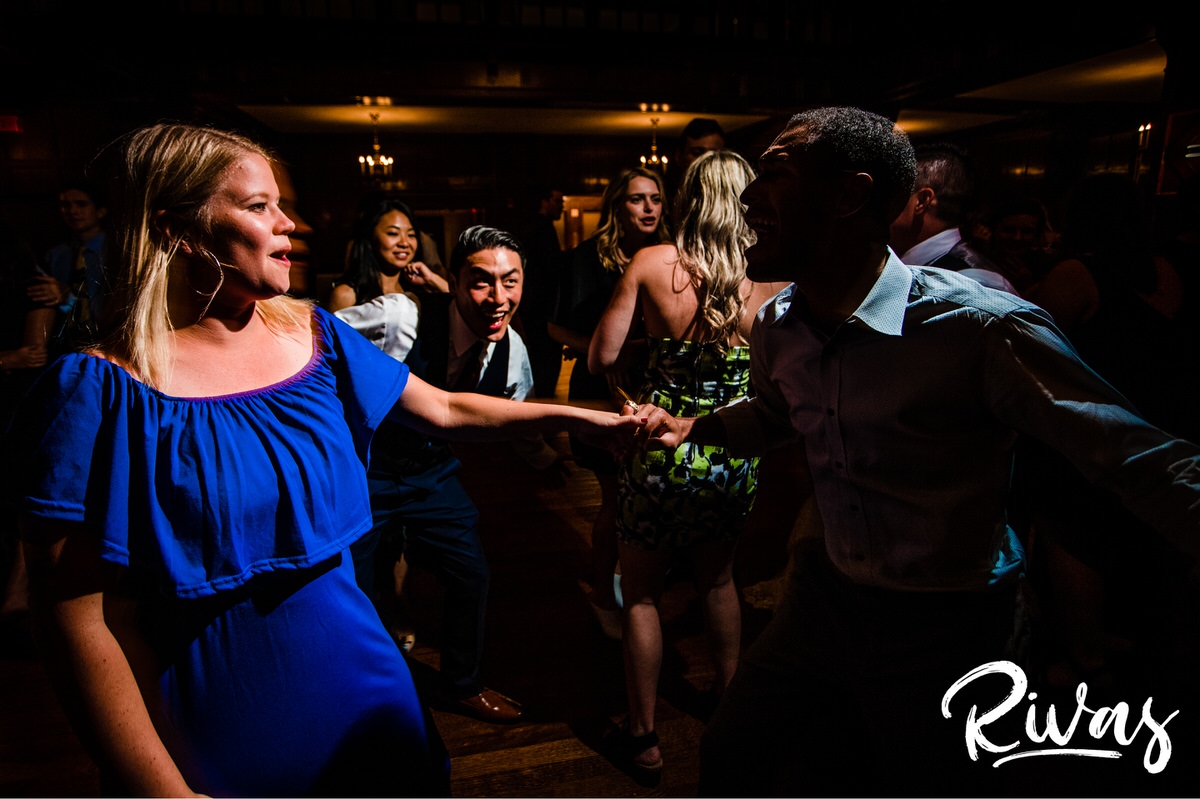 Strawberry Hill Summer Wedding | Rivas Photography | Kansas City Wedding Pictures | A candid photo taken during a wedding reception held in The Tudor Room at Kansas City's Brass on Baltimore of reception attendees and friends excitedly singing and dancing on the dance floor. 