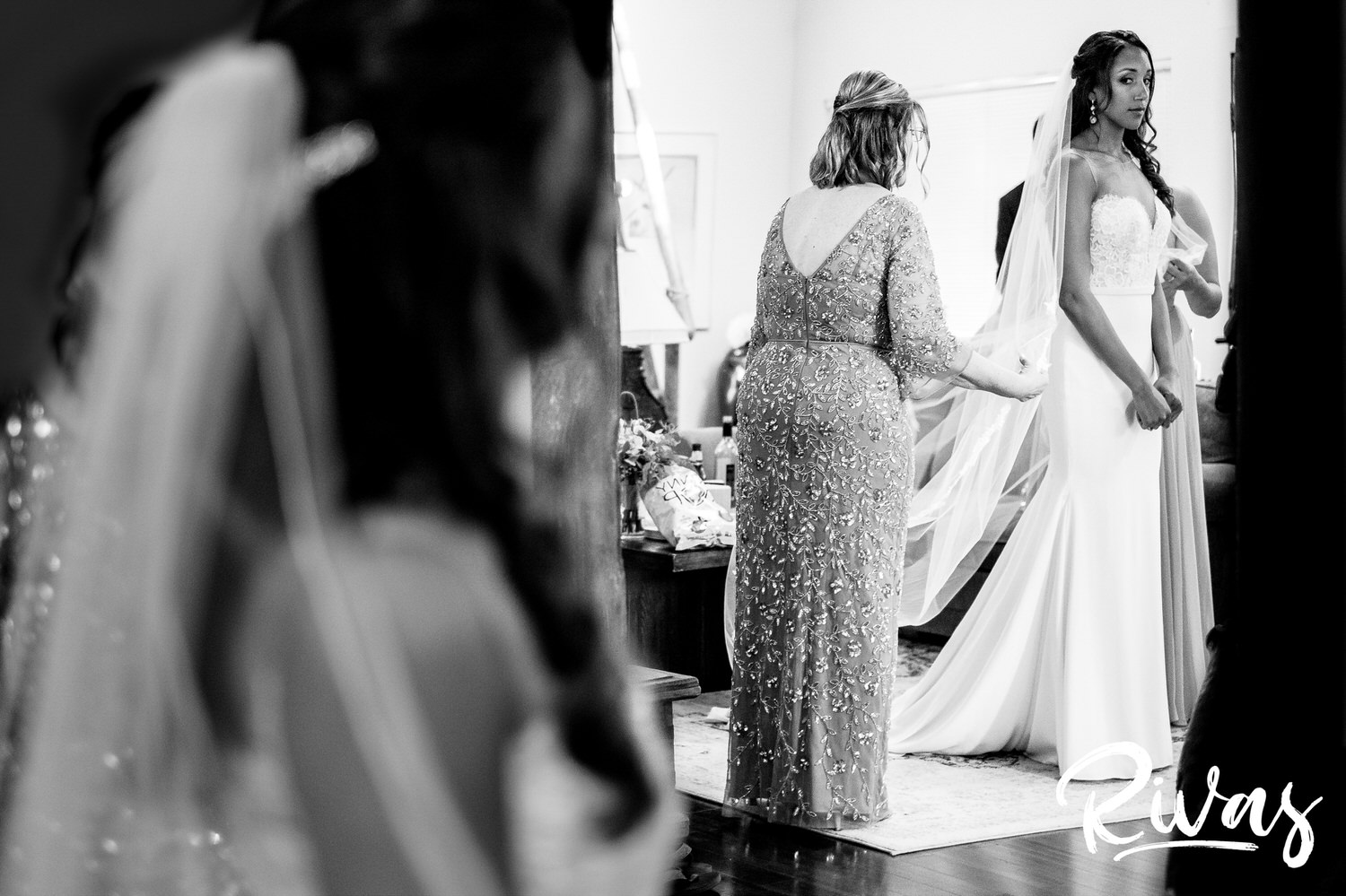Saddlerock Ranch Summer Wedding | Destination Wedding Photographers | Rivas | A black and white portrait of a bride's mom putting in her veil before she walks down the aisle on her wedding day at Saddlerock Ranch in Malibu, California. 