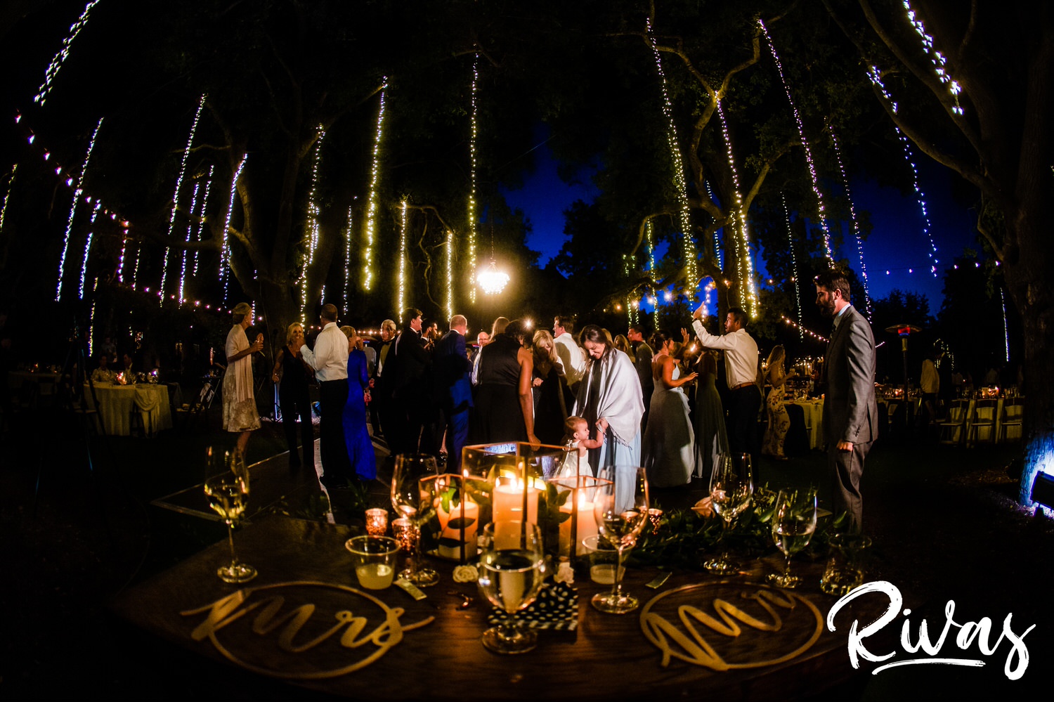 Saddlerock Ranch Summer Wedding | Destination Wedding Photographers | Rivas | A side photograph taken from the angle of the sweetheart table of a dance floor full of wedding guests during a reception at Saddlerock Ranch. 