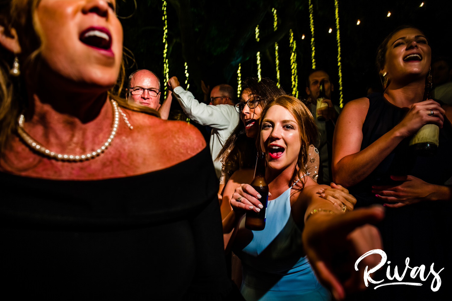Saddlerock Ranch Summer Wedding | Destination Wedding Photographers | Rivas | A candid picture of a bridesmaid in the middle of the dance floor at a wedding reception at Saddlerock Ranch in Malibu, California. 