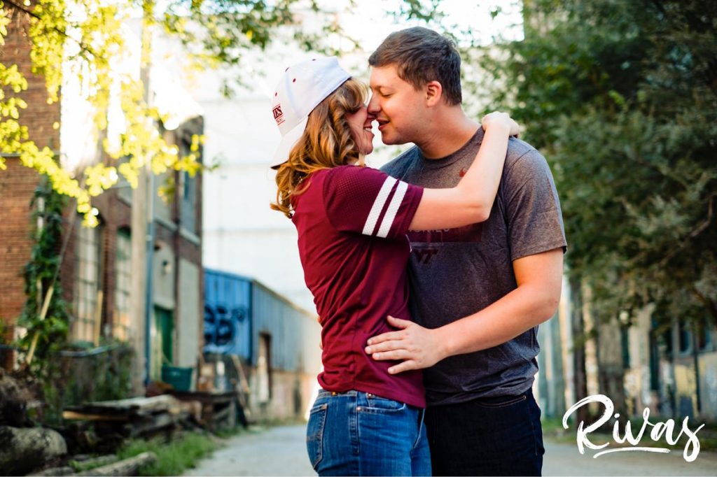 West Bottoms Engagement Pictures | A candid photo of an engaged couple embracing and sharing a kiss during their engagement session. 