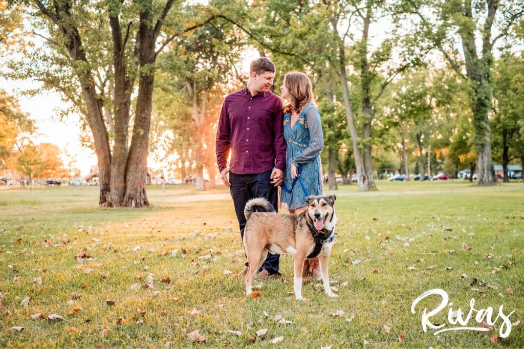West Bottoms Engagement Pictures | A candid photo of an engaged couple walking their dog through English Landing Park at sunset. 