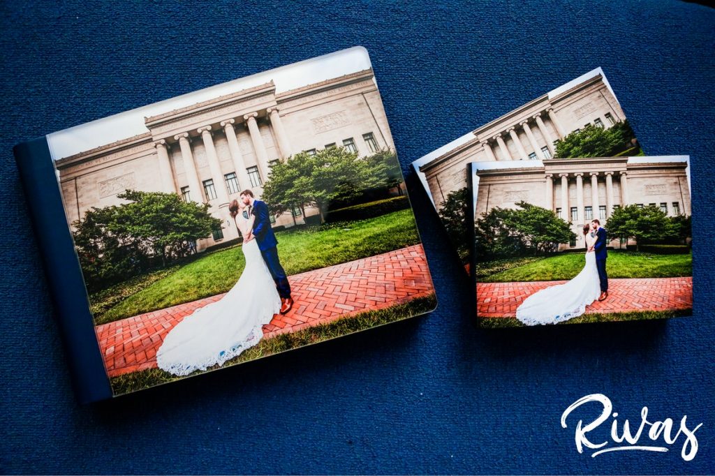 Maroon & Navy Custom Wedding Album | A staged photo of a custom wedding album on a blue background with matching parent books. 