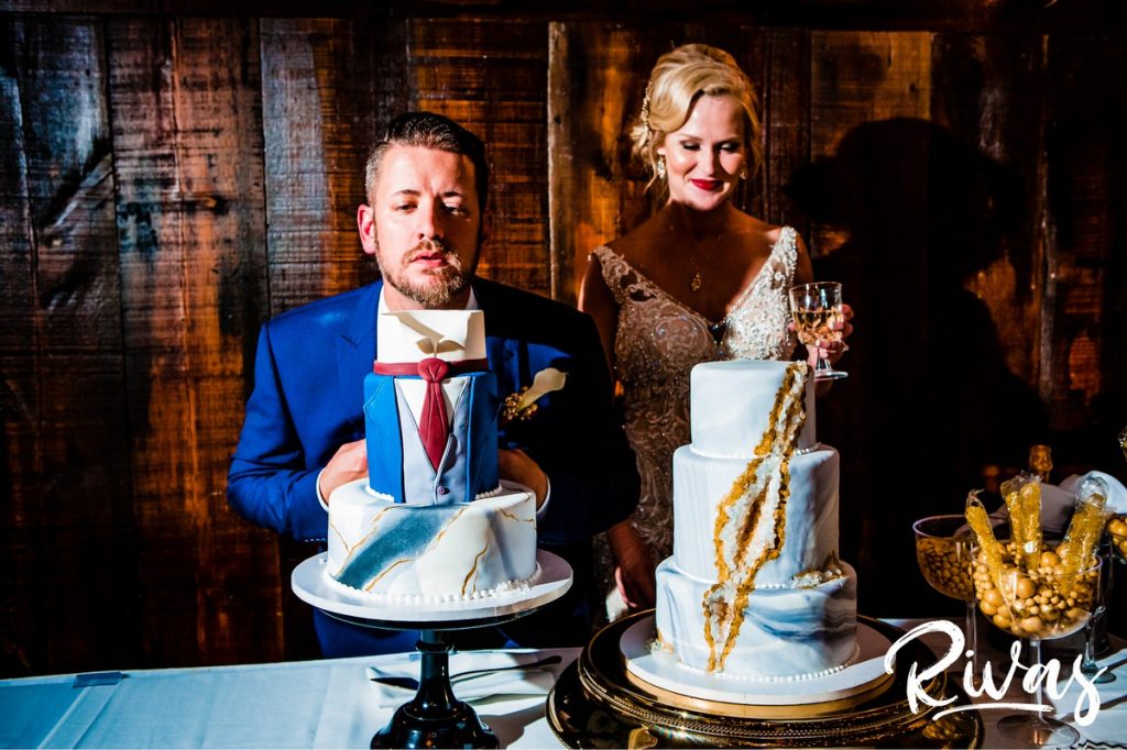 Art Deco Inspired Wedding in Kansas City- A candid picture taken during a wedding reception at Californos of a groom leaning his head over his groom's cake, decorated to look just like his suit. 