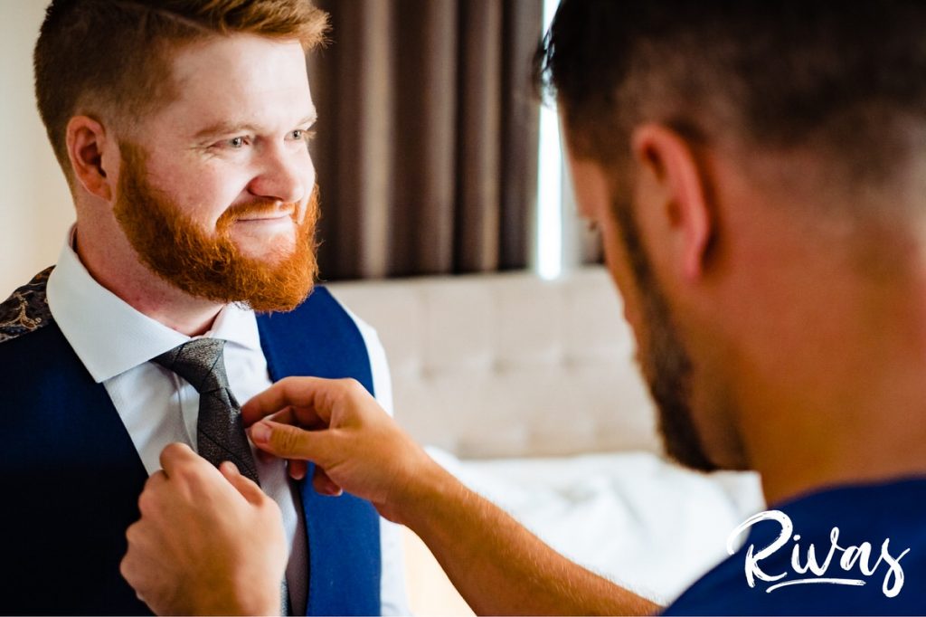 Art Deco Inspired Wedding in Kansas City | A candid picture of a man tying his brother's tie. 
