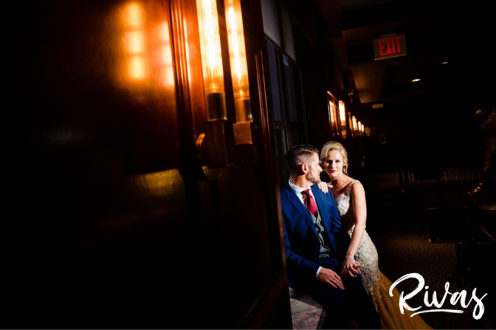 Art Deco Inspired Wedding in Kansas City | A dramatic portrait of a bride and groom leaning against a windowsill of Hotel Phillips in downtown Kansas City just moments after sharing their first look on their wedding day. 