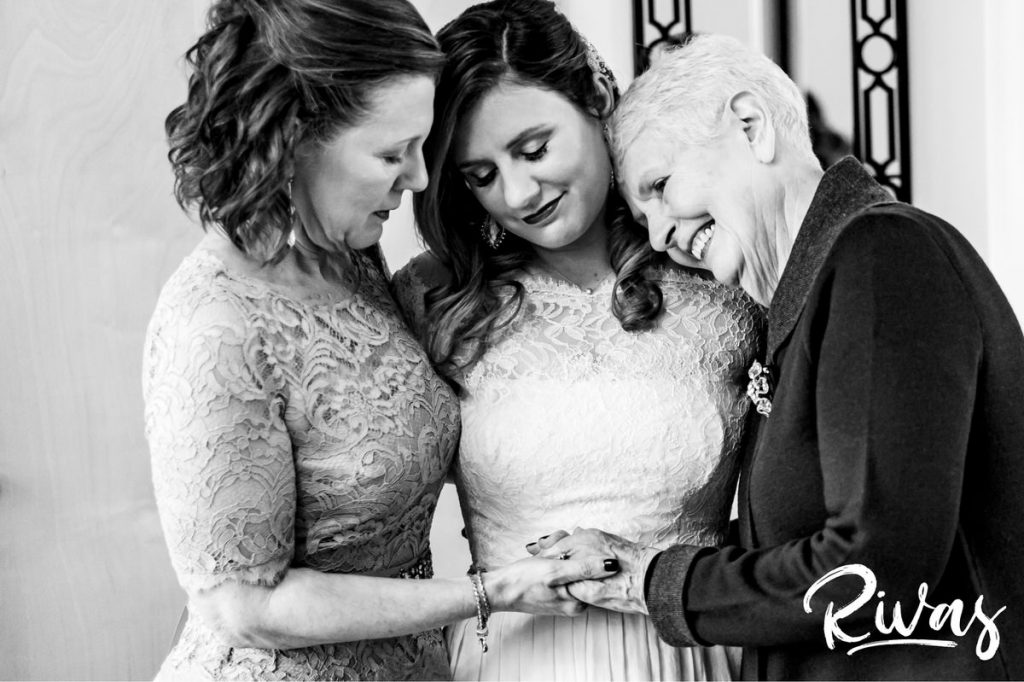 Downtown KC Library Wedding | A black and white picture of a bride, her mom, and grandma sharing an embrace on the morning of her wedding day. 