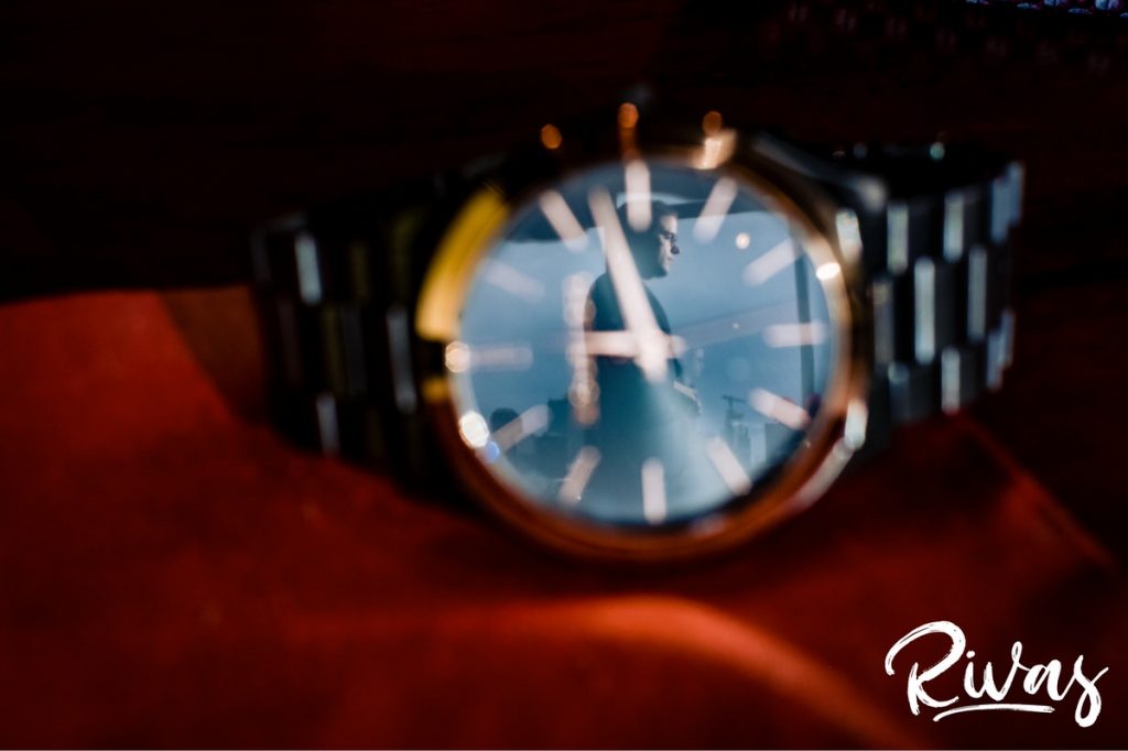 Downtown KC Library Wedding | A detailed picture of a watch face, with a silhouette of a groom and the Kansas City Skyline in the reflection of the watch. 