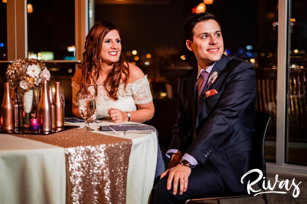 Downtown KC Library Wedding - Rivas Photography | A candid picture of a bride and groom watching in eager anticipation as the bride's parents welcome everyone to their wedding reception at Boulevard Brewing Company. 