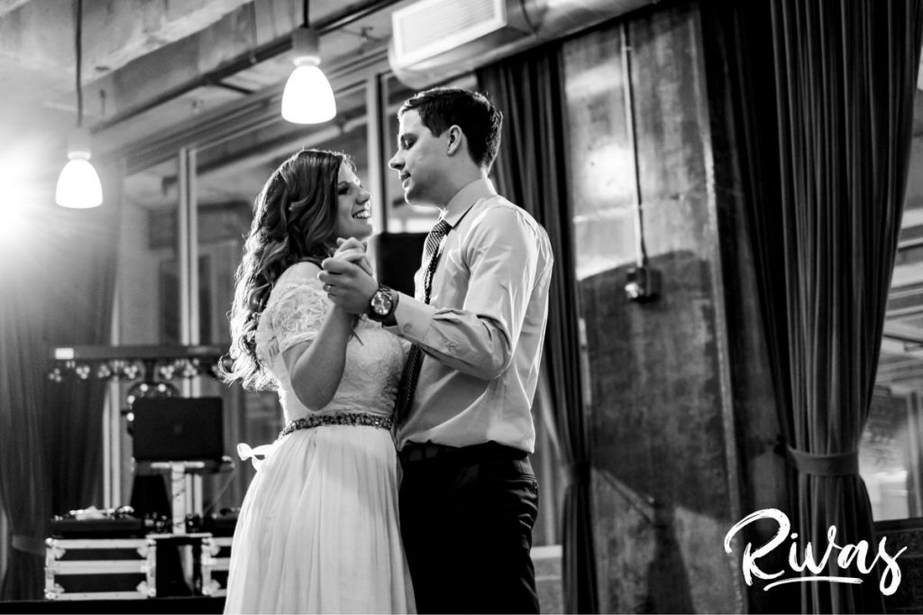 Downtown KC Library Wedding - Rivas Photography | A black and white picture of a bride and groom doing a choreographed first dance during their wedding reception at Boulevard Brewing Company. 