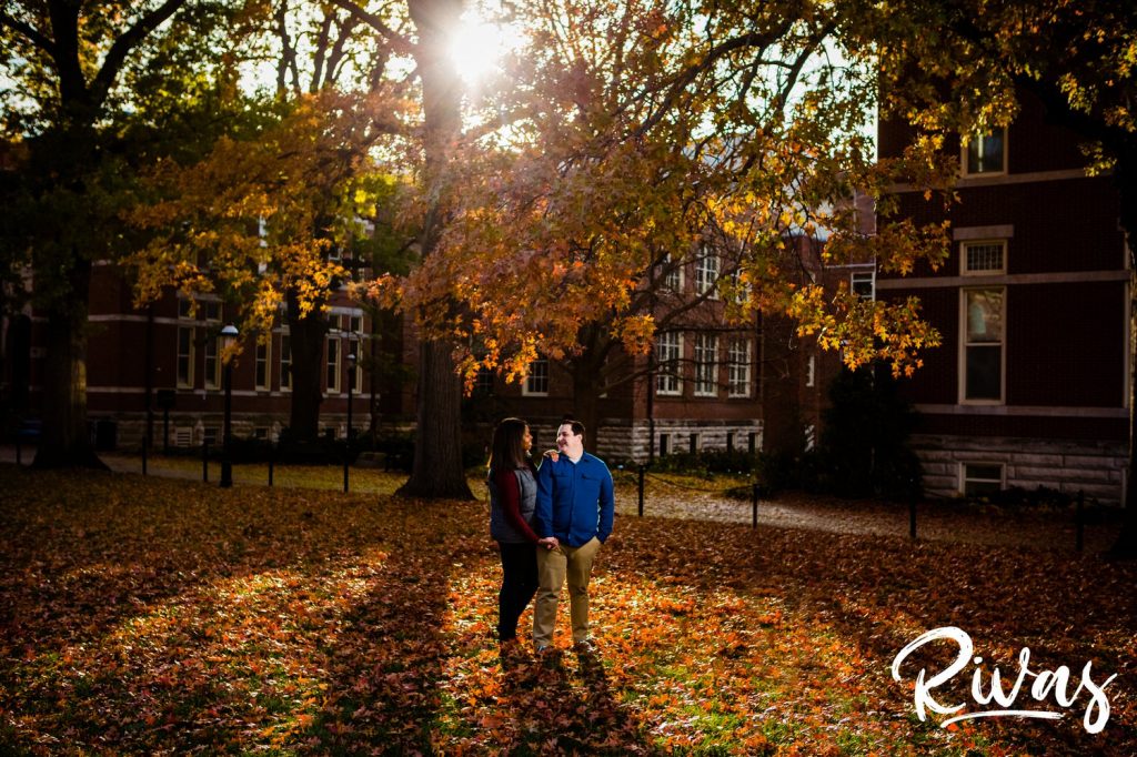 Fall MU Engagement Session | A wide, colorful picture of an engaged couple dressed casually standing underneath a colorful canopy of fall leaves on Mizzou's campus during their engagement session.