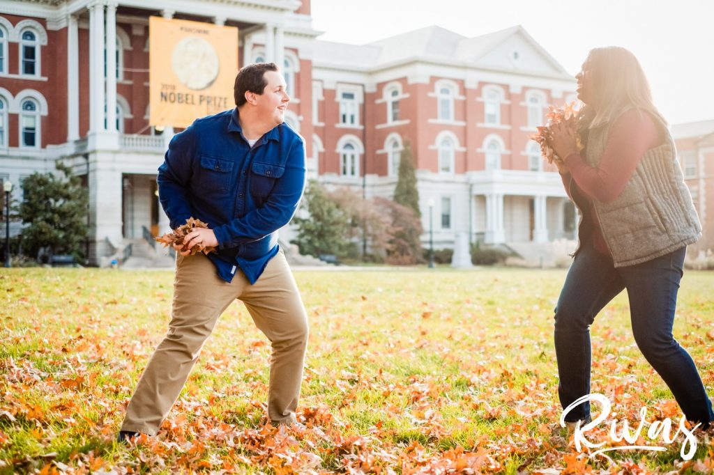 Fall MU Engagement Session | A candid picture of an engaged couple standing in a colorful yard of leaves during their engagement session in Columbia at MU.